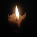 Candle glowing in the dark
